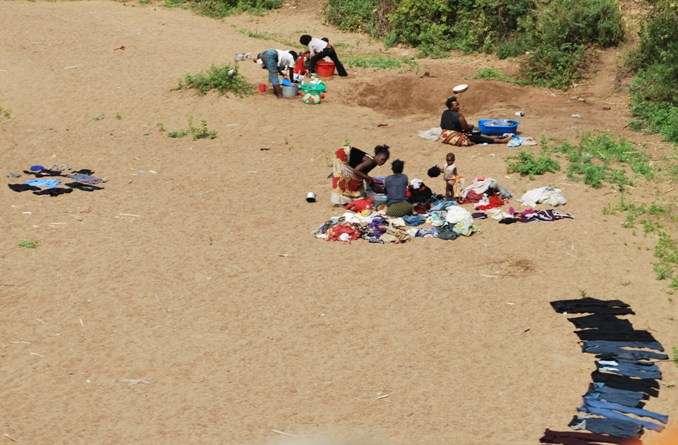 Washing Clothes By Hand In The River By African Women