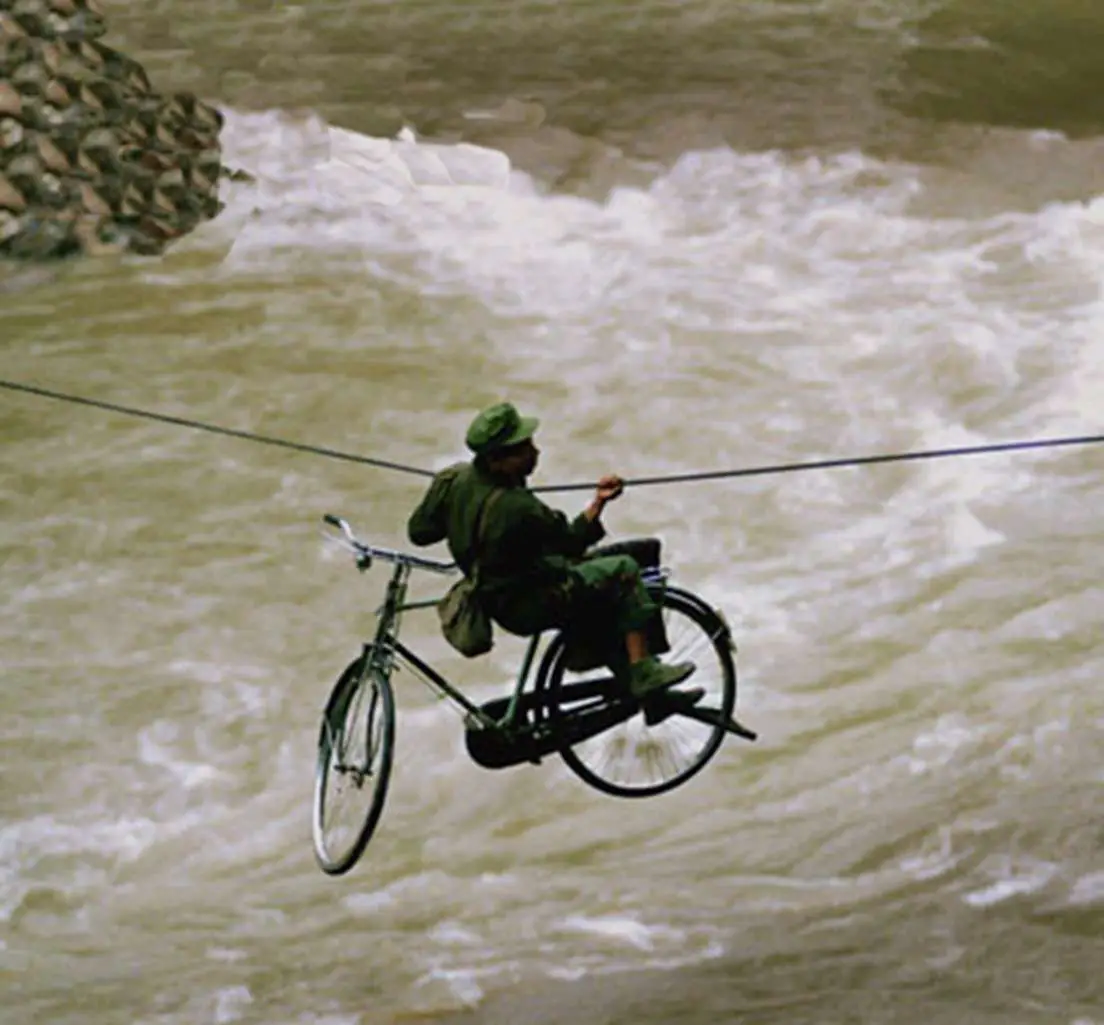 Crossing River On Rope With Bike