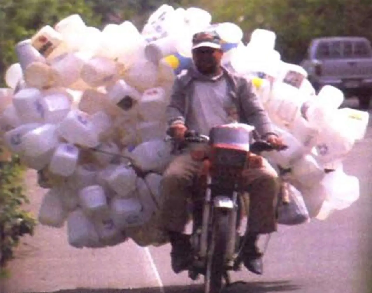Scooter Overloaded With Plastic Bottles