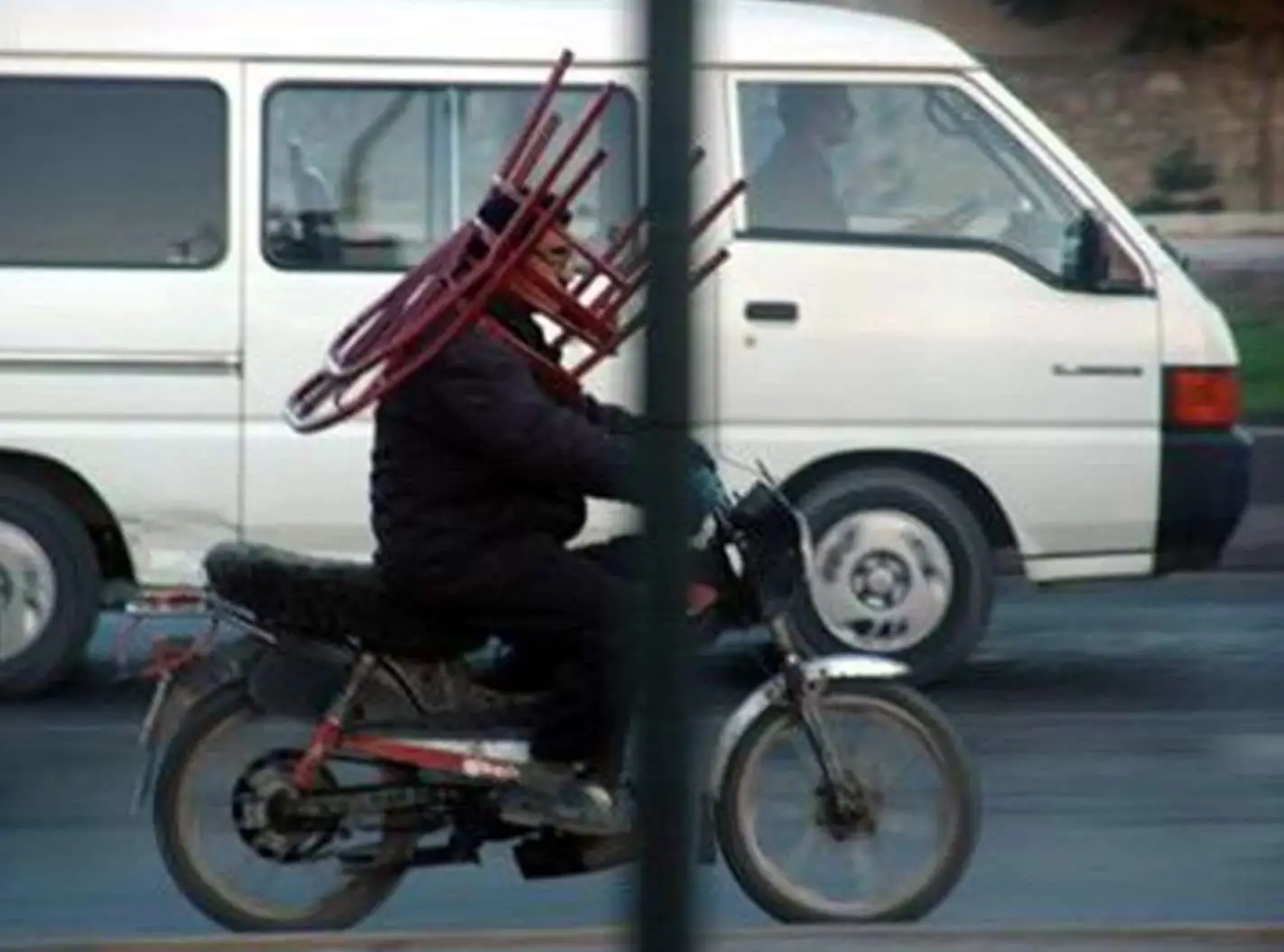Transporting Chair On Head On Motorbike