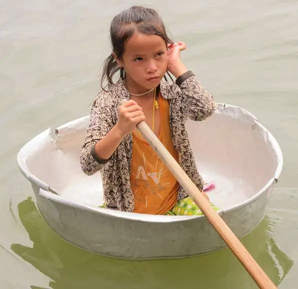 Water Transport - Floating Washing Bucket And Little Girl Paddling In Cambodia